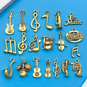 Conjunto detallado de dijes de instrumentos musicales en oro viejo sobre azul