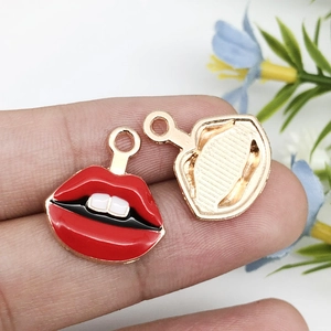 Macro detail of red lips enamel charm with golden textured back for DIY jewelry crafts