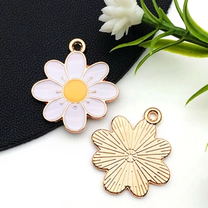 Vue détaillée des pendentifs marguerite en émail blanc avec placage en or rose pour DIY