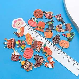 Assorted fall enamel charms featuring pumpkins and owls on a bright blue background