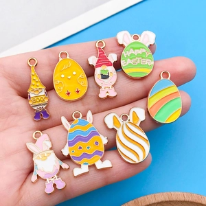 Detail of assorted colorful enamel Easter and Halloween charms held by hand