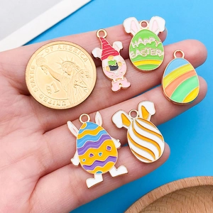 Detailed view of colorful enamel Easter charms with a coin for size reference
