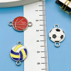 Detailed macro view of 20mm zinc alloy sports charms with basketball and soccer patterns