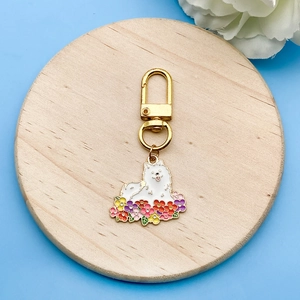 Detail of dog pendant keychain with colorful flowers on a light blue background