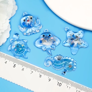 Sky blue translucent sea creature charms with glitter including turtle and seahorse