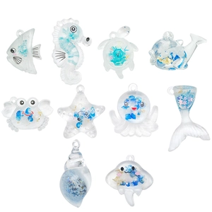 Set of 10 transparent acrylic ocean animal pendants with blue sand and gold foil inside