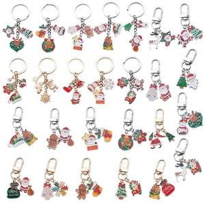 Close-up of enamel Christmas keychains featuring Santa, reindeer, and festive charms