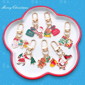 Detailed close-up of colorful Christmas enamel keychains set in a ceramic tray