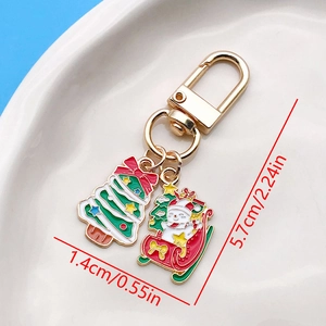Macro shot of colorful enamel Christmas tree and snowman keychain charms with dimensions