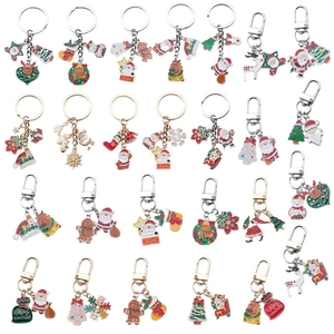Set of 24 colorful Christmas enamel keychains featuring Santa, reindeer and tree designs
