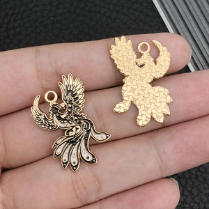 Gothic style black and gold enamel dragon pendant with detailed textured metal back