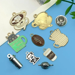 Collection of vintage coffee themed enamel charms including cups, beans and coffee grinders