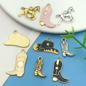 Detail view of pink and black western cowboy boot charms for DIY jewelry making accessories