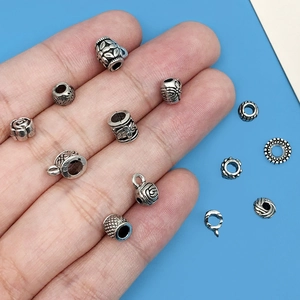 Macro shot of antique silver alloy beads and charms for DIY jewelry handmade crafts