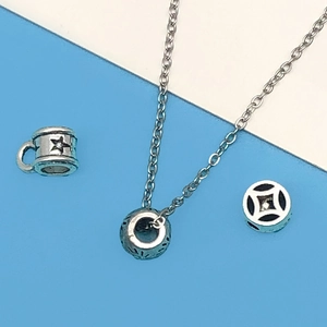 Detailed macro of antique silver spacer beads and multi-style pendant jewelry accessories