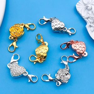 Macro view of heart and rose magnetic jewelry connectors in gold and silver plating
