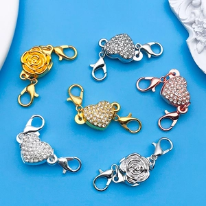 Detail of heart and rose magnetic jewelry clasps with lobster hooks in gold and silver