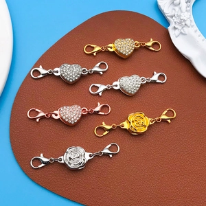Detail of heart and rose shaped magnetic jewelry clasps in gold, silver and rose gold