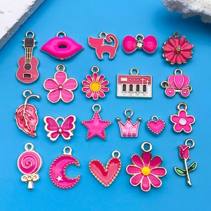 Macro detail of 20 rose pink enamel charms with golden edges for DIY jewelry making