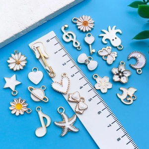 White enamel alloy charms with gold edges including music notes and floral shapes