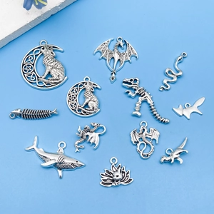 Detailed view of assorted vintage silver alloy animal pendants with wolf and dragon motifs