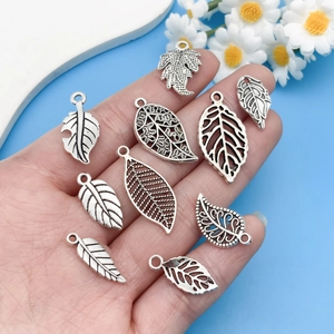Detailed collection of antique silver leaf alloy charms with hollow vein textures