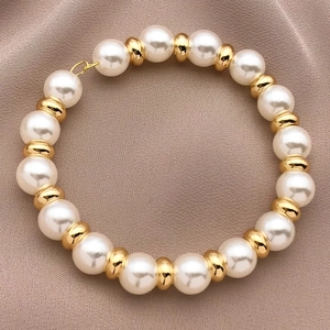 18K gold-plated spacer beads with white round pearls on elegant silk fabric background