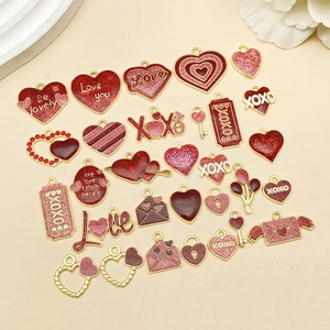Detailed flat lay of pink and red enamel heart charms for DIY jewelry making