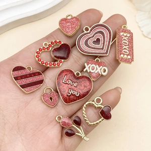 Detailed close-up of mixed pink rose and heart charms for Valentine's Day DIY jewelry