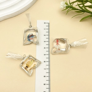 Macro shot of 3D resin goldfish water bag charms with ruler showing 4cm size detail