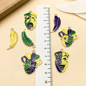 Detail of Mardi Gras mask and feather charms with measurement scale on beige background