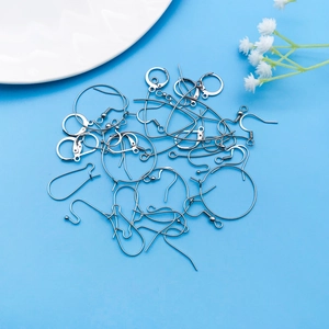 Polished silver stainless steel French ear hook assortments on a blue background