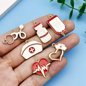 Detail view of medical charms including stethoscope and nurse hat held in hand