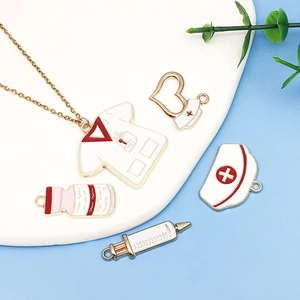 Detail view of medical enamel charms set with doctor coat and syringe pendant on display