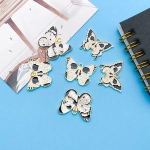 Gothic skull butterfly pendants with black and white drip oil finish in a set for DIY jewelry