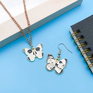 Gothic skull butterfly pendant necklace and earrings set with dark enamel finish