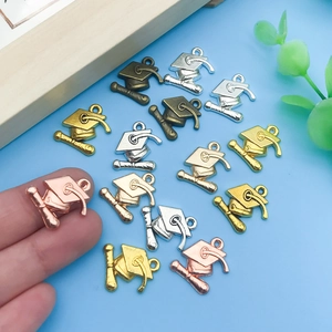 Gros plan de breloques chapeau de diplômé colorées pour bijoux DIY et porte-clés