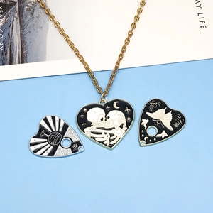 Macro detail of heart enamel pendants featuring skull, butterfly and striped motifs