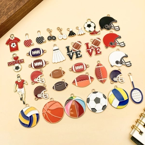 Detailed flat lay of colorful enamel sports pendants featuring soccer and basketball charms