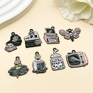 Detailed view of 8 gothic pink and black enamel Halloween charms for DIY jewelry making