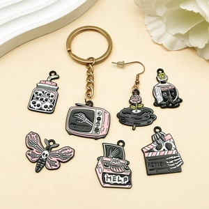 Pink and black Halloween skull charms set including keychain and earrings for DIY