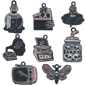 Pink and black gothic Halloween charms set with skull patterns on white background