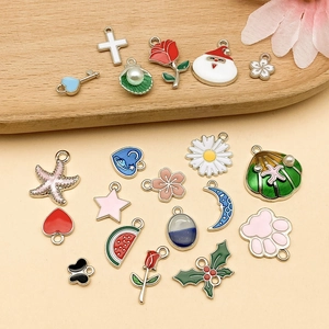 Close-up of DIY colorful enamel charms with floral and star motifs for jewelry making