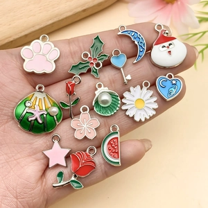 Close-up of assorted alloy enamel charms including roses and flowers for DIY jewelry