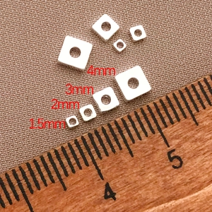 Macro shot of silver square spacer beads in sizes 1.5mm to 4mm for DIY jewelry making