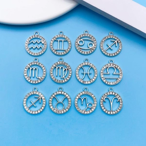 Macro detail of twelve zodiac signs silver plated pendants with white rhinestones