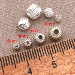 Primer plano de cuentas espaciadoras de metal con relieve para joyería DIY en varios tamaños