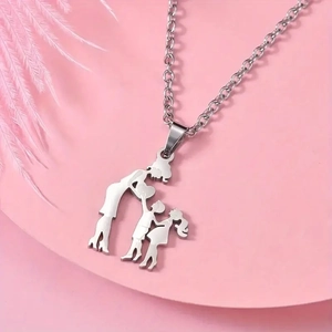 Close-up of a silver stainless steel family pendant showing mother and two children