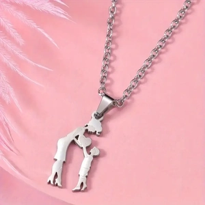 Detail of silver stainless steel mother and child silhouette pendant on pink feather background