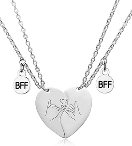 Close-up of split heart BFF necklaces with pinky swear engraving and silver finish